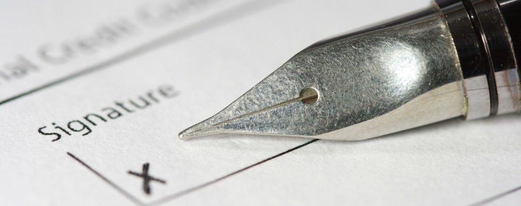 metal fountain pen on signature paper